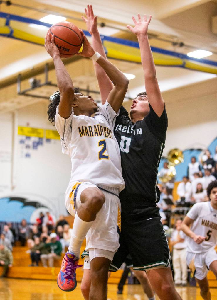 Mariners Jailin Johnson attempts a layup while being guarded by Jacksons Caden Sproul during the game on Wednesday in Everett. (Olivia Vanni / The Herald)