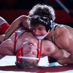 Arlington's Dustin Baxter works to pin Stanwood's Cameron O'Neill in the 145lb weight class at Stanwood High School Thursday evening in Stanwood, Washington on January 6, 2022. The Spartans defeated the Eagles 50-21.  (Kevin Clark / The Herald)