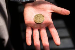Eric Brossard displays his commemorative Drug Court graduation coin that reads, "I came with hope, worked and learned. I have a new life. A life that I've earned." (Olivia Vanni / The Herald)