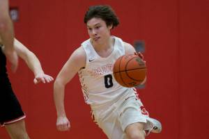 Stanwood's Owen Thayer takes the ball down the court during the game against Mountlake Terrace on Thursday, Jan. 20, 2022 in Stanwood, Washington. (Olivia Vanni / The Herald)