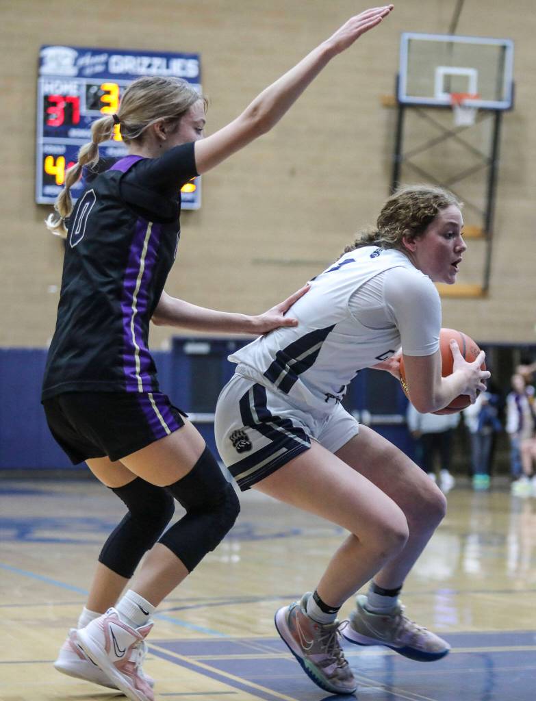 Lake Stevens Ella Edens (0) chases after Glacier Peaks Brynna Pukis during a game between the Lake Stevens Vikings and Glacier Peak Grizzlies on Friday in Snohomish. The Grizzlies won 51-32. (Annie Barker / The Herald)