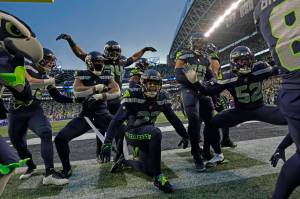 The Seattle Seahawks celebrate after an interception by safety Quandre Diggs during overtime Sundays game against the Los Angeles Rams in Seattle. (AP Photo/Abbie Parr)