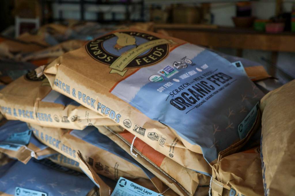 Organic feed sits in the garage at Hearth and Haven Farm in Monroe, Washington on Wednesday, Jan. 11, 2023. (Annie Barker / The Herald)