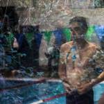 A reflection of a swimmer preparing to race during the Jackson vs. Kamiak boys swim and dive meet at West Coast Aquatics in Mill Creek, Washington on Tuesday Jan. 10, 2023. (Annie Barker / The Herald)