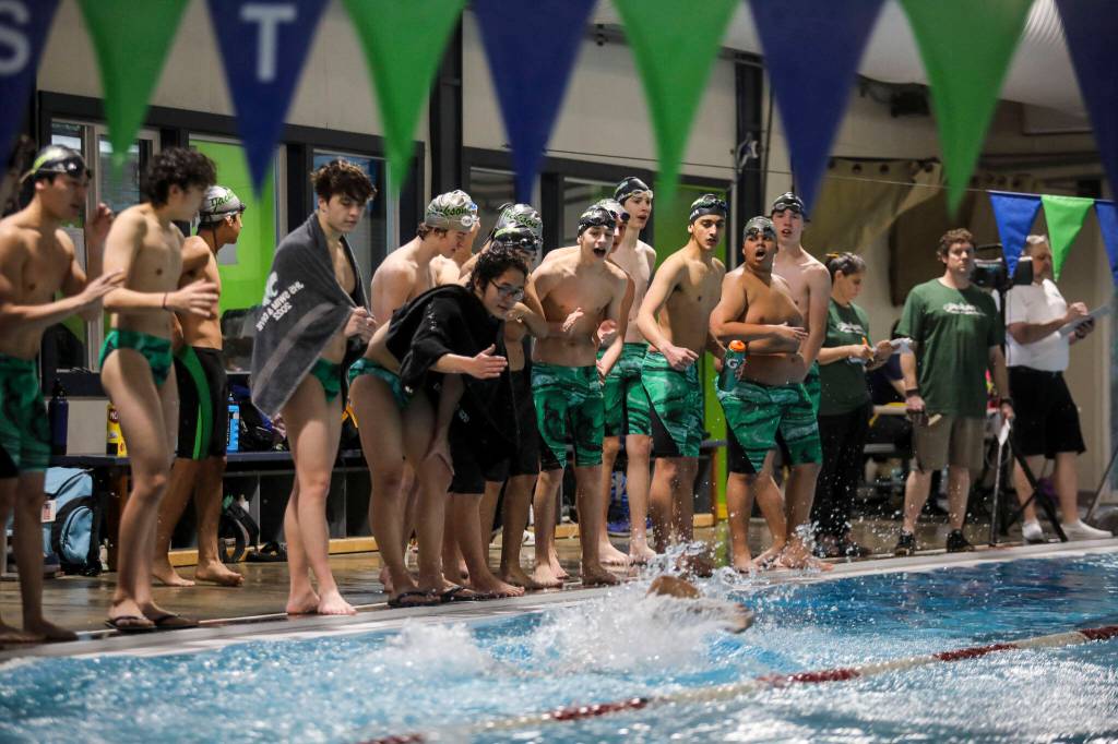 Swimmers cheer during the Jackson vs. Kamiak boys swim and dive meet at West Coast Aquatics in Mill Creek, Washington on Tuesday Jan. 10, 2023. (Annie Barker / The Herald)