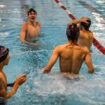 Kamiaks Jack Fast, left, looks at the time clock board during the Jackson vs. Kamiak boys swim and dive meet at West Coast Aquatics in Mill Creek, Washington on Tuesday Jan. 10, 2023. (Annie Barker / The Herald)