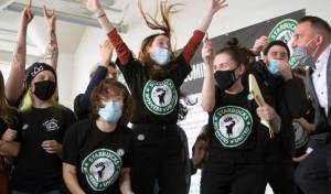 FILE - Starbucks employees and supporters react as votes are read during a viewing of their union election on Thursday, Dec. 9, 2021, in Buffalo, N.Y. One year after a Starbucks in Buffalo became the first to unionize in decades - touching off a wave of labor actions at other big companies like Amazon and Chipotle - the rush to organize Starbucks stores has slowed. (AP Photo/Joshua Bessex, File)
