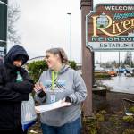 Catholic Community Services NW Director of Housing Services and Everett Family Center Director Rita Jo Case, right, speaks to Jason Browning, left, during a point-in-time count of people facing homelessness on Tuesday, in Everett. Browning sometimes stays along Casino Road and tries to help clean up after others in the area. (Annie Barker / The Herald)