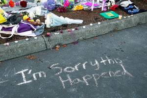 Messages are left at a memorial in the parking lot of Kamiak High School Sunday, July 31, 2016, after a community vigil for the victims of a shooting that occurred early Saturday morning at a house in Mukilteo, Wash., killing three teenagers and wounding one.  (Genna Martin/seattlepi.com via AP)