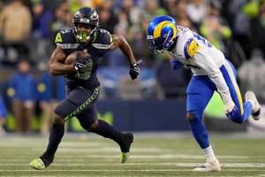Seattle Seahawks running back Kenneth Walker III (9) carries the ball against the Los Angeles Rams during overtime of an NFL football game Sunday, Jan. 8, 2023, in Seattle. (AP Photo/Abbie Parr)