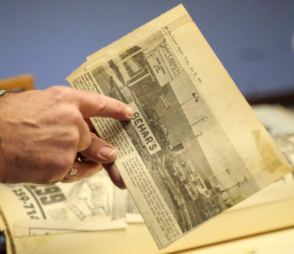 Store owner Jay Behar, 50, points at an ad from 1971 at Behars Furniture on Monday. Behars Furniture on Broadway in Everett is closing up shop after 60 years in business. The family-owned furniture store opened in 1963, when mid-century model styles were all the rage. Second-generation owner, Jay Behar says its time to move on. (Annie Barker / The Herald)