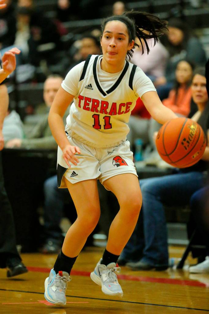 Mountlake Terraces Maile Armstrong passes down to the paint against Meadowdale on Wednesday, Jan.11, 2023, at Mountlake Terrace High School in Mountlake Terrace, Washington. (Ryan Berry / The Herald)