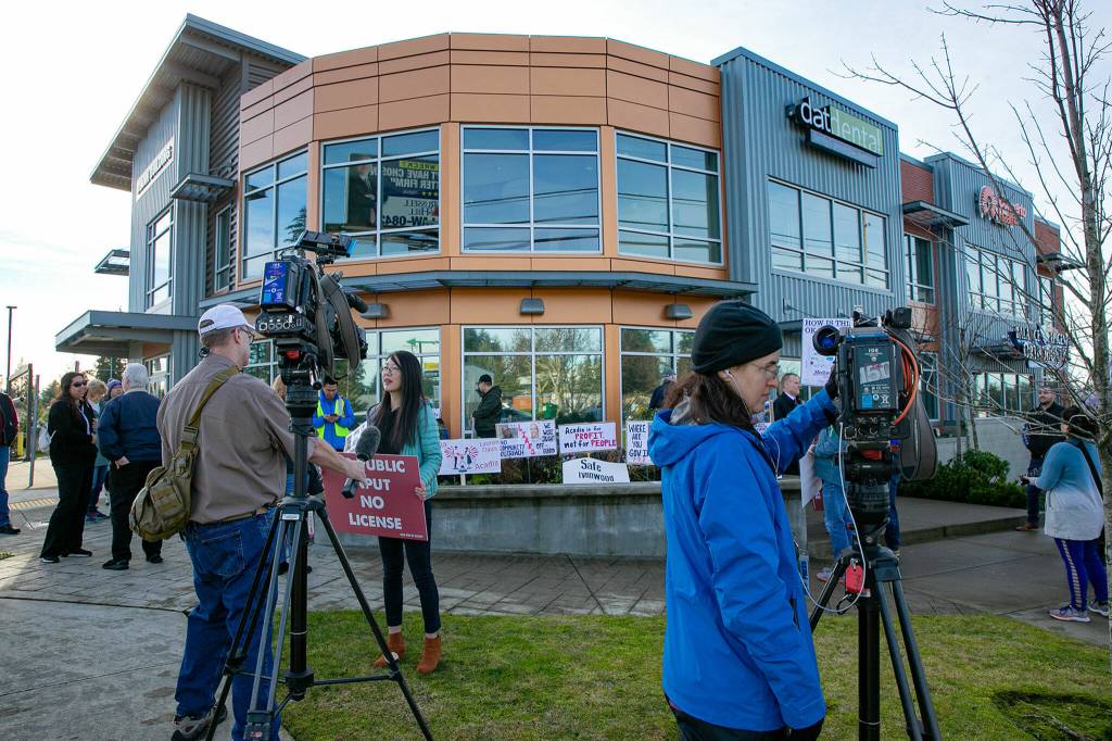 Media and supporters begin to gather during a protest against the opening of a methadone clinic on Saturday, Jan. 14, 2023, in Lynnwood, Washington. (Ryan Berry / The Herald)