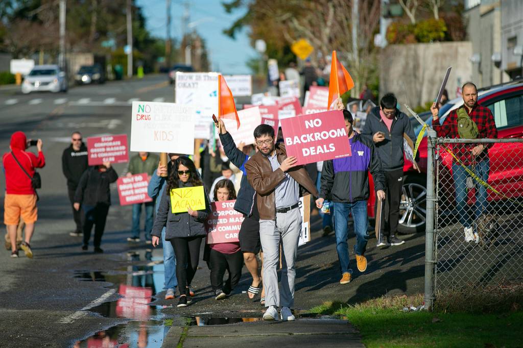 Demonstrators walk a short distance from a future methadone clinic to the Alderwood Boys & Girls Club during a protest against the clinic on Saturday, Jan. 14, 2023, in Lynnwood, Washington. (Ryan Berry / The Herald)