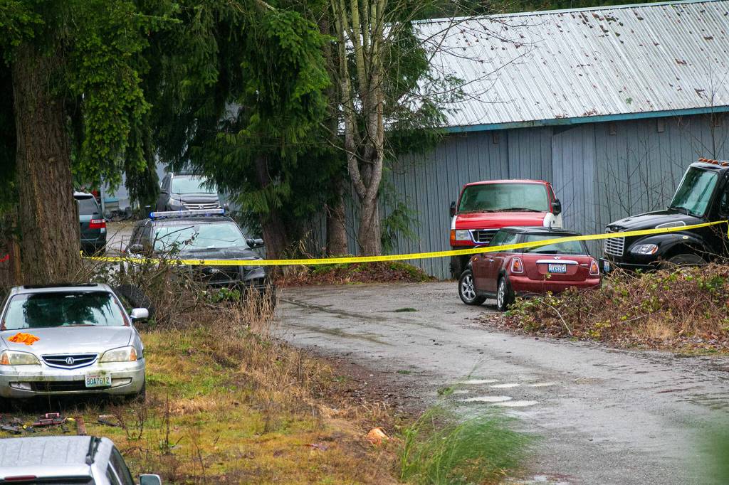 Police tape blocks off an area between two businesses in a residential area along 20th Street SE near Route 9 after a police-involved shooting that left one person dead Friday, in Lake Stevens. (Ryan Berry / The Herald)
