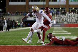 Washington wide receiver Rome Odunze (1) runs for a touchdown during the second half of an NCAA college football game against Washington State, Saturday, Nov. 26, 2022, in Pullman, Wash. Washington won 51-33. (AP Photo/Young Kwak)