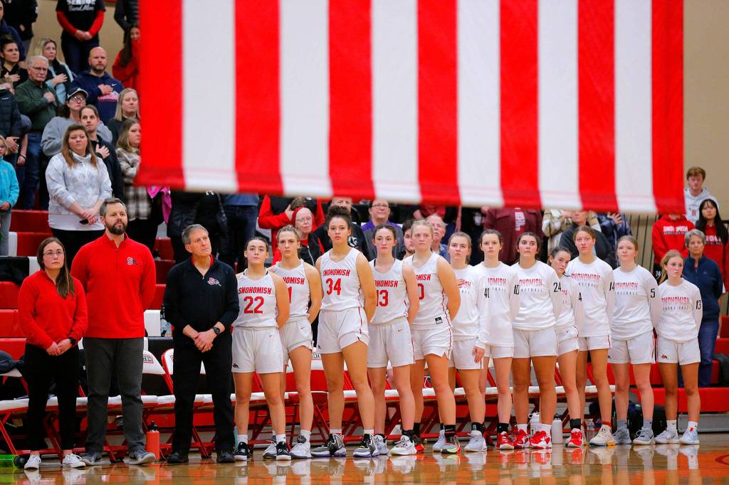 The Snohomish Panthers stand for the National Anthem prior to their matchup with Stanwood on Friday, Jan. 13, 2023, at Snohomish High School in Snohomish, Washington. (Ryan Berry / The Herald)
