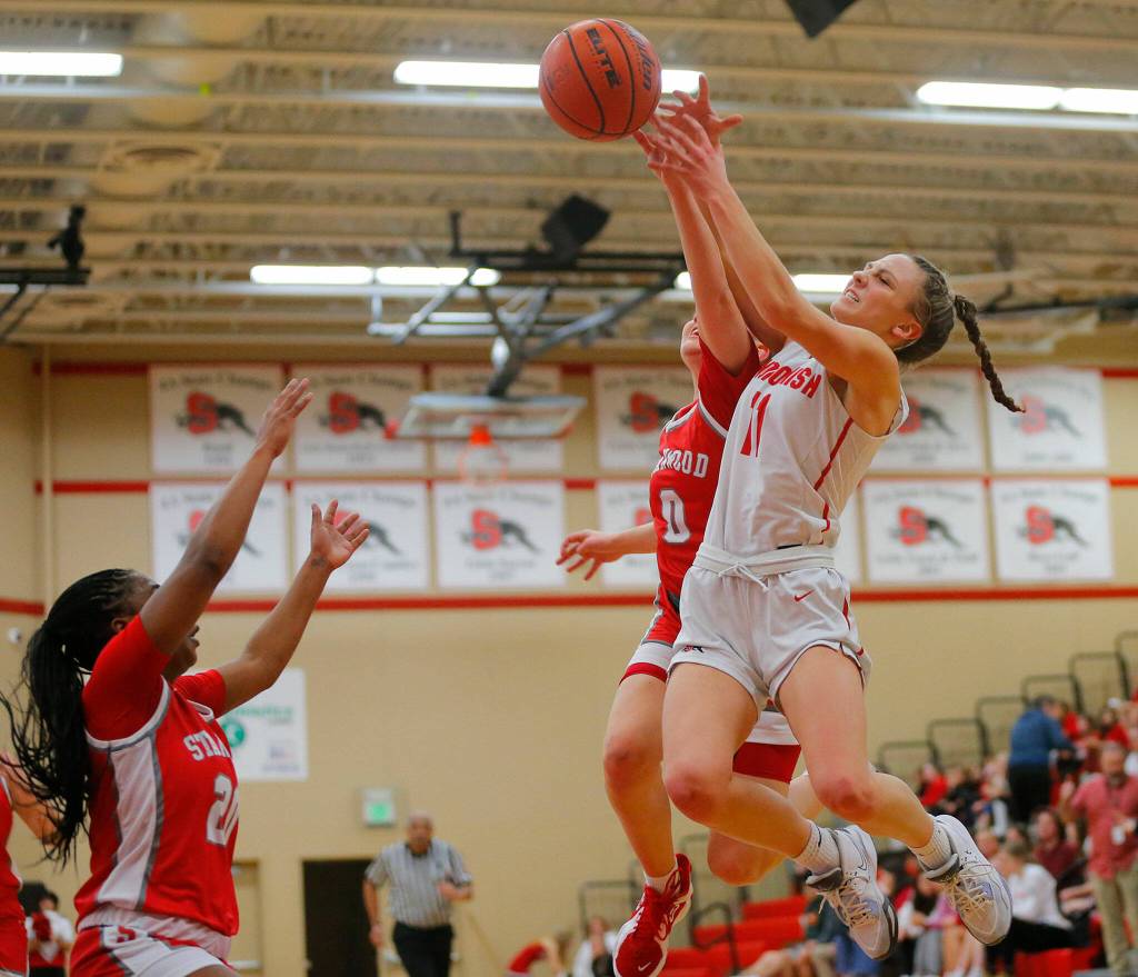 Snohomishs Baella Stich and Stanwoods Grace Walker take to the air to try and grab an errant pass on Friday, Jan. 13, 2023, at Snohomish High School in Snohomish, Washington. (Ryan Berry / The Herald)