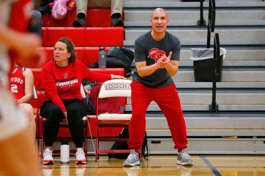 Stanwood head coach Dustin Swanson cheers on his team as they hold onto a late lead against Snohomish on Friday, Jan. 13, 2023, at Snohomish High School in Snohomish, Washington. (Ryan Berry / The Herald)