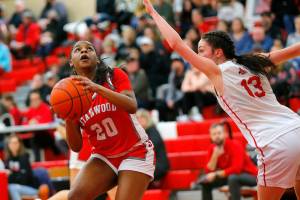 Stanwood’s Chloe Santeford spins away from a defender before shooting the ball against Snohomish on Friday, Jan. 13, 2023, at Snohomish High School in Snohomish, Washington. (Ryan Berry / The Herald)