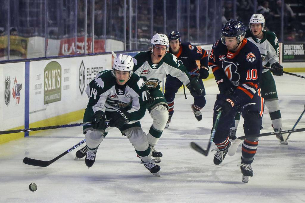 Silvertips Austin Roest (14) chases after the puck against Kamloops Ryan Hofer (10) during a game between the Silvertips and Kamloops Blazers at the Angel of the Winds Arena on Friday, Jan. 13, 2023. The Silvertips fell to the Kamloops, 3-6. (Annie Barker / The Herald)