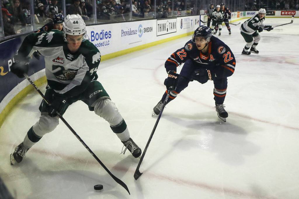 Silvertips Aidan Sutter (44) fights for the puck against Kamloops Daylan Kuefler (22) during a game between the Silvertips and Kamloops Blazers at the Angel of the Winds Arena on Friday, Jan. 13, 2023. The Silvertips fell to the Kamloops, 3-6. (Annie Barker / The Herald)