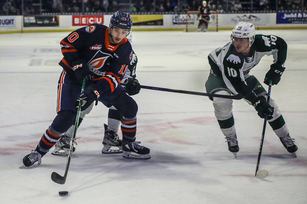 Kamloops Ryan Hofer (10) and Silvertips Beau Courtney (10) fight for the puck during a game between the Silvertips and Kamloops Blazers at the Angel of the Winds Arena on Friday, Jan. 13, 2023. The Silvertips fell to the Kamloops, 3-6. (Annie Barker / The Herald)