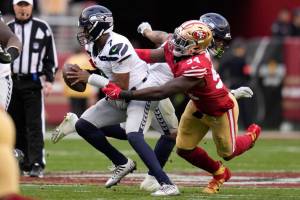 Seattle Seahawks quarterback Geno Smith (7) is pressured by San Francisco 49ers defensive end Charles Omenihu (94) during the second half of an NFL wild card playoff football game in Santa Clara, Calif., Saturday, Jan. 14, 2023. (AP Photo/Godofredo A. Vásquez)