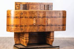 The art deco period began about 100 years ago and has not lost its appeal. This geometric cabinet with wood veneers is an example of the style.