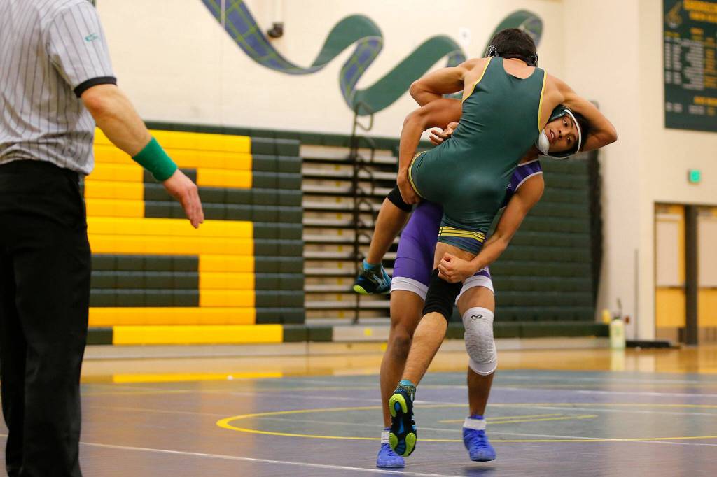 Edmonds-Woodways Joseph Martinez lifts Shorecrests Brian Ramirez before slamming him to the mat on Wednesday, Jan. 18, 2023, at Shorecrest High School in Shoreline, Washington. (Ryan Berry / The Herald)