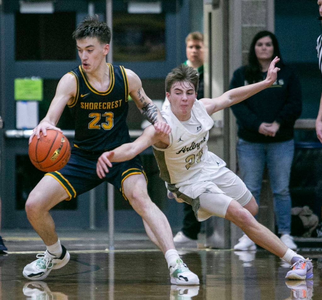 Arlingtons Leyton Martin tries to steal the ball from Shorecrests Parker Baumann during the game on Thursday, Jan. 19, 2023 in Arlington, Washington. (Olivia Vanni / The Herald)