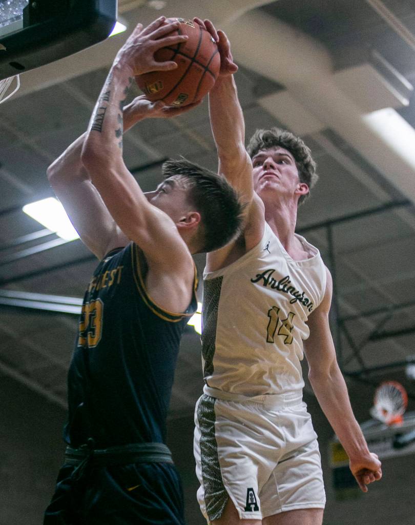Arlingtons David Zachman blocks a shot by Shorecrests Parker Baumann during the game on Thursday, Jan. 19, 2023 in Arlington, Washington. (Olivia Vanni / The Herald)