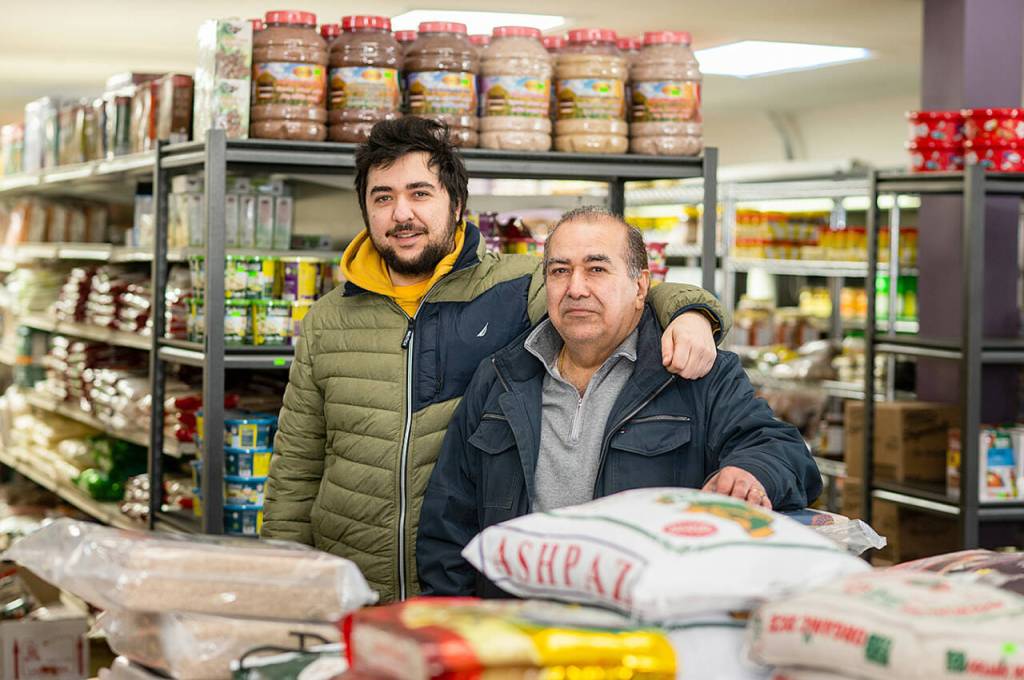 Raj Kumar Jawa poses for a photo with his son, Raj, at India Sweets & Spices in Culver City, California. (Mitch Dao / YES! Media)