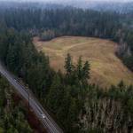 Cars move along Frank Waters Road next to a contaminated land site purchased by Robinett Brothers on Tuesday, Jan. 24, 2023 in Stanwood, Washington. (Olivia Vanni / The Herald)