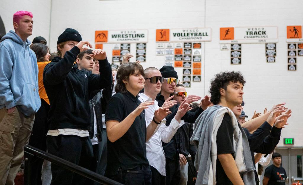 Monroe students wiggle their fingers for good luck during a free-throw during a game between the Monroe Bearcats and the Edmonds-Woodway Warriors at Monroe High School in Monroe, on Jan. 20. The Bearcats defeated the Warriors, 68-57. (Annie Barker / The Herald)