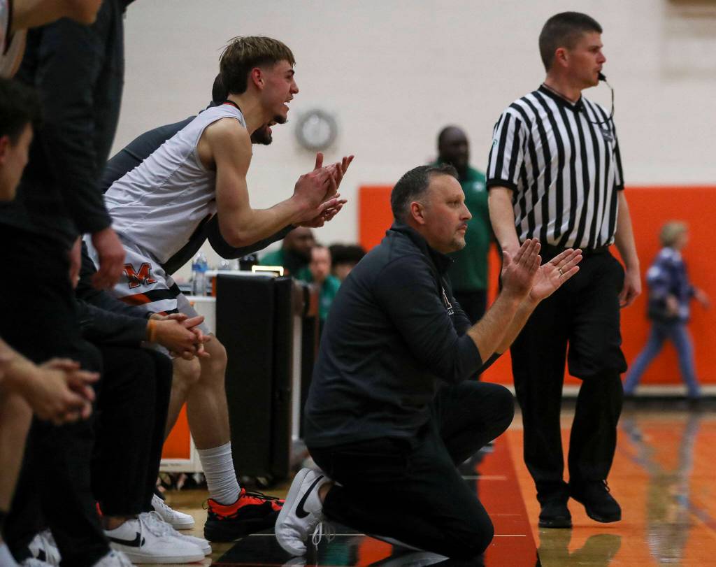 Monroes Steve Kuhnle (1) left, and head coach Justin Prohn, right, cheer and yell during a game between the Monroe Bearcats and the Edmonds-Woodway Warriors at Monroe High School in Monroe on Jan. 20. The Bearcats defeated the Warriors, 68-57. (Annie Barker / The Herald)