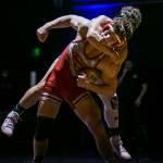 Arlingtons Dustin Baxter hangs on the back of Stanwoods Ryder Bumgarner during the 170 pound weight class match on Tuesday, Jan. 24, 2023 in Arlington, Washington. (Olivia Vanni / The Herald)