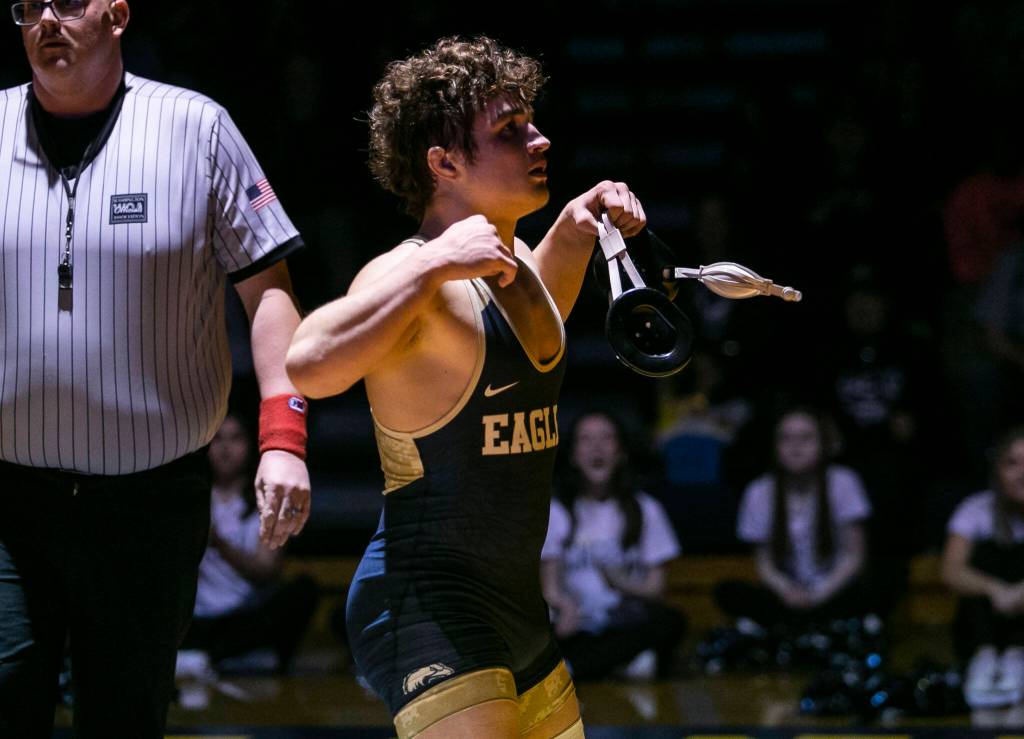 Arlingtons Dustin Baxter flexes after winning the 170 pound weight class match on Tuesday, Jan. 24, 2023 in Arlington, Washington. (Olivia Vanni / The Herald)