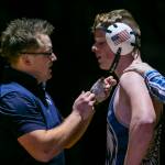 Arlington coaches help Holden Strande with nose bleed during the 195 pound weight class match on Tuesday, Jan. 24, 2023 in Arlington, Washington. (Olivia Vanni / The Herald)