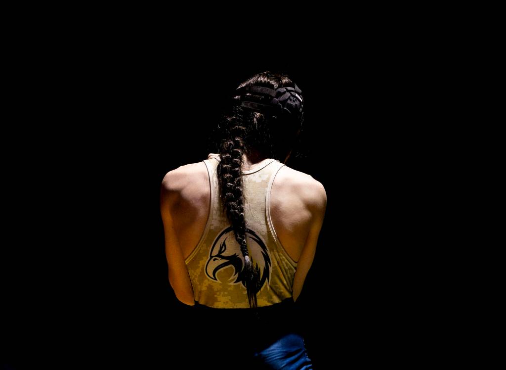 Arlington AJ Dorchak adjusts his headgear during the 113 pound weight class match on Tuesday, Jan. 24, 2023 in Arlington, Washington. (Olivia Vanni / The Herald)