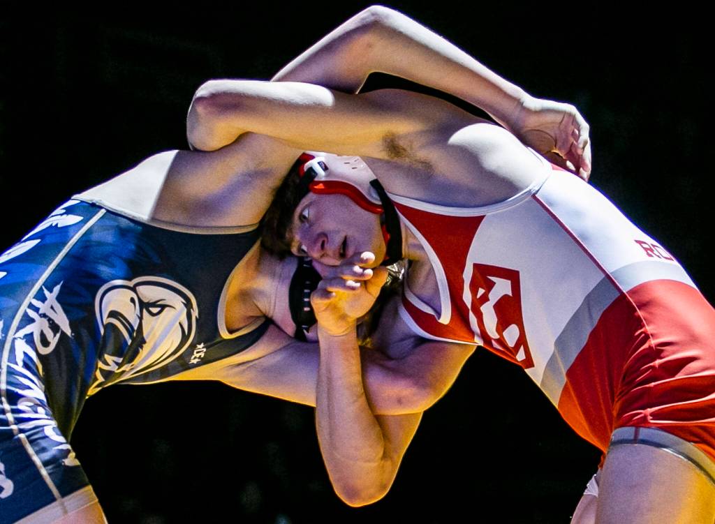 Arlingtons Beau Gudde and Stanwoods Bryan Roodzant lock arms during the 126 pound weight class match on Tuesday, Jan. 24, 2023 in Arlington, Washington. (Olivia Vanni / The Herald)