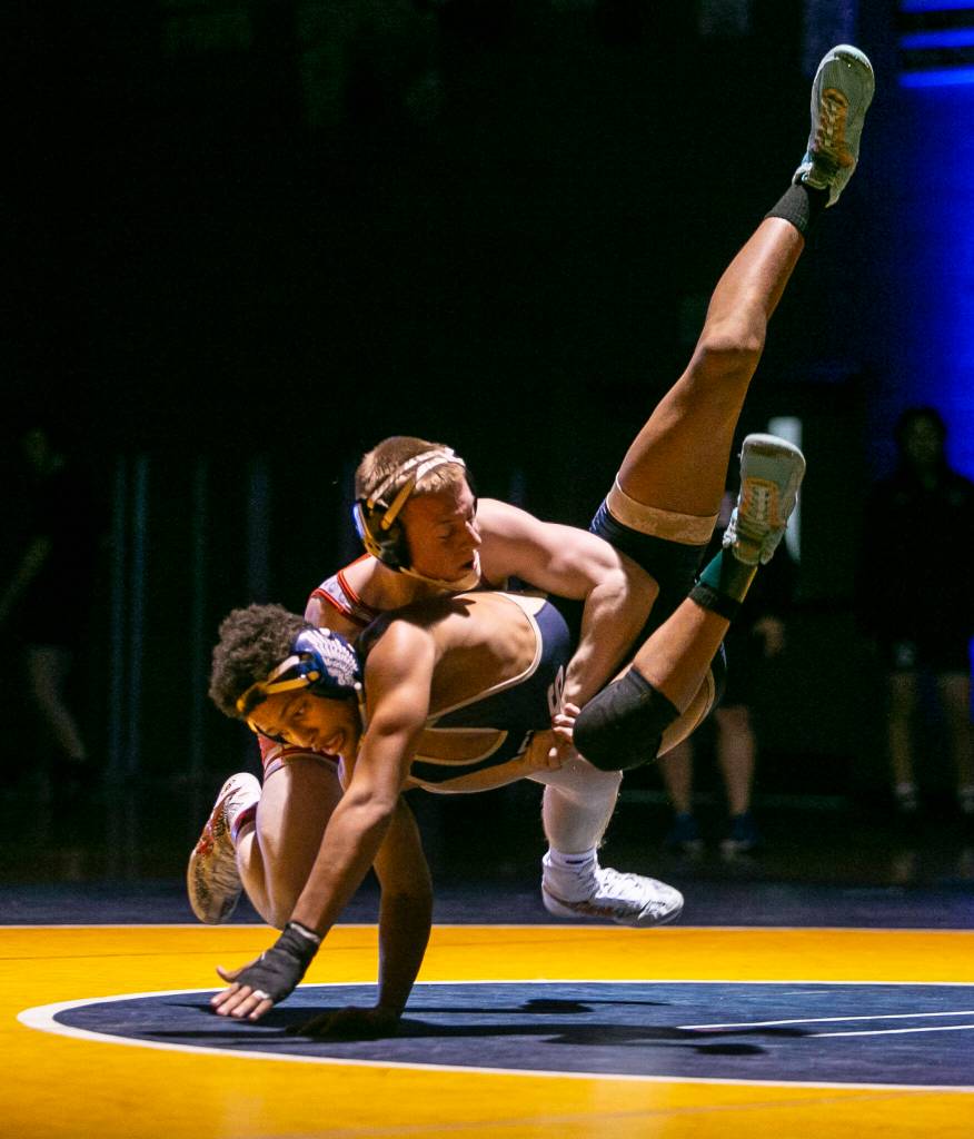 Stanwoods Tyler Rhue throws Arlingtons Tre Haines during the 145 pound weight class match on Tuesday, Jan. 24, 2023 in Arlington, Washington. (Olivia Vanni / The Herald)