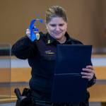 Edmonds Police Chief Michelle Bennett presents K-9 Hobbs and Sgt. Jason Robinson with a medal during Hobbs retirement ceremony at the Edmonds Police Department on Thursday, in Edmonds. (Annie Barker / The Herald)