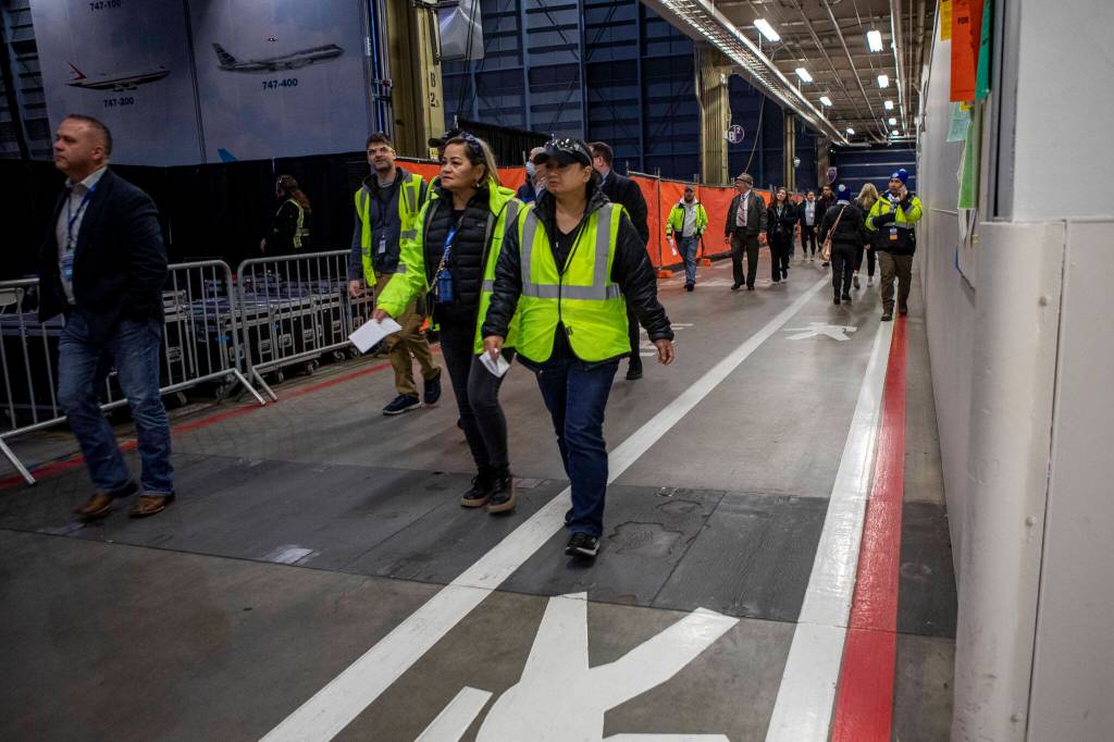 People enter a celebration on Tuesday, at the 747 factory in Everett. (Annie Barker / The Herald)