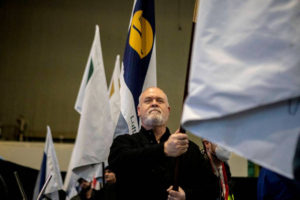 Flag bearers march during a celebration on Tuesday, at the 747 factory in Everett. (Annie Barker / The Herald)