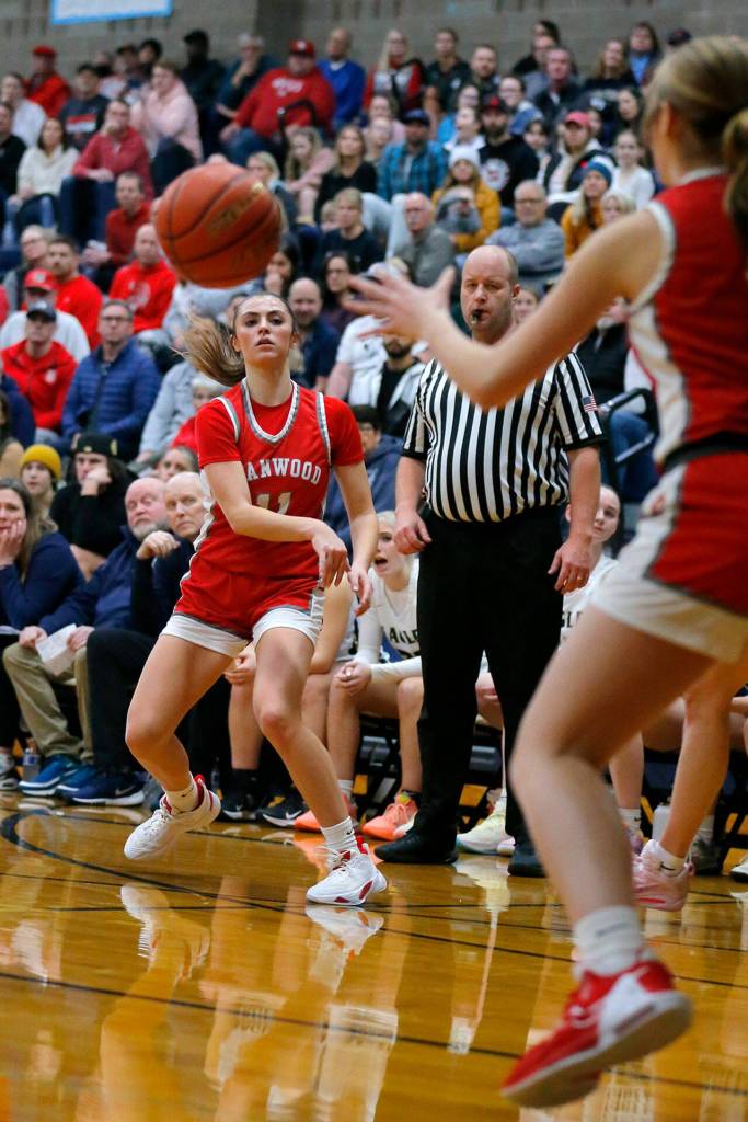 Stanwoods Tatum Brager passes down low to EllaLee Wortham for an assist against Arlington on Wednesday, Jan. 25, 2023, at Arlington High School in Arlington, Washington. (Ryan Berry / The Herald)