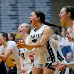 The Arlington bench cheers on their team as they approach a victory over Stanwood on Wednesday, Jan. 25, 2023, at Arlington High School in Arlington, Washington. (Ryan Berry / The Herald)
