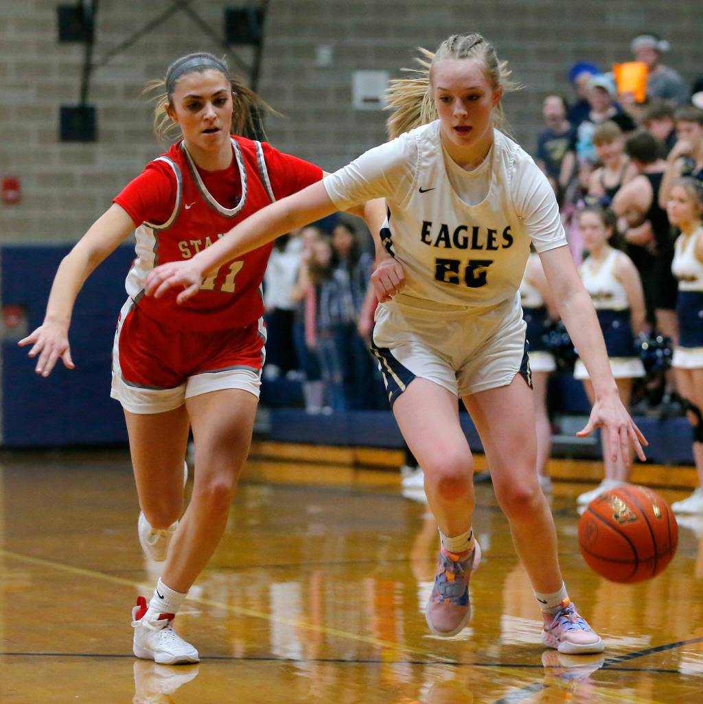 Arlingtons Kierra Reese tries to keep away from a defender against Stanwood on Wednesday, Jan. 25, 2023, at Arlington High School in Arlington, Washington. (Ryan Berry / The Herald)