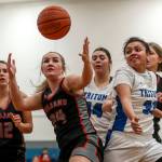 ECCs Grace Trichler (24) fights for the ball during a womens game between the Everett Community College Trojans and Edmonds College Tritons at Seaview Gymnasium at Edmonds College in Lynnwood, Washington on Wednesday Jan. 25, 2023. The Tritons won, 65-52. (Annie Barker / The Herald)