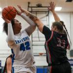 ECs Layla Young (42) and ECCs Abbie Juozapatis (33) fight for the ball during a womens game between the Everett Community College Trojans and Edmonds College Tritons at Seaview Gymnasium at Edmonds College in Lynnwood, Washington on Wednesday Jan. 25, 2023. The Tritons won, 65-52. (Annie Barker / The Herald)